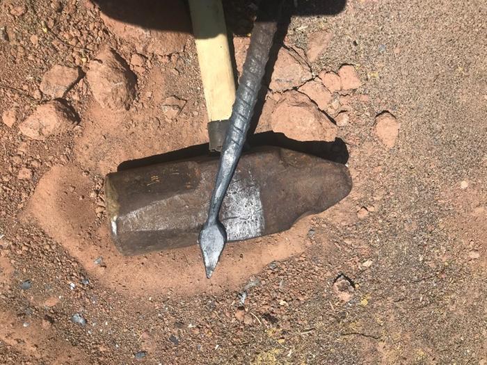 a flattened leaf shaped piece of wrought iron being worked