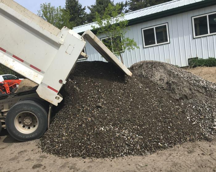 crushed urbanite being dumped out of a dump truck