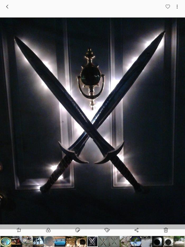 swords crossed hanging on door