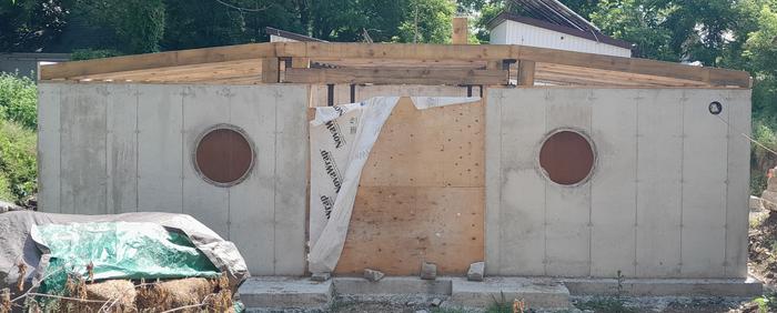 front view of hobbit home with wooden beams in place