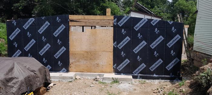 hobbit house with waterproofing on exposed wall