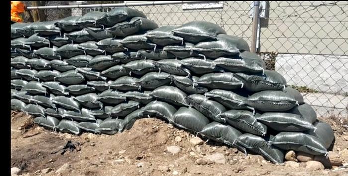 a wall of black sandbags