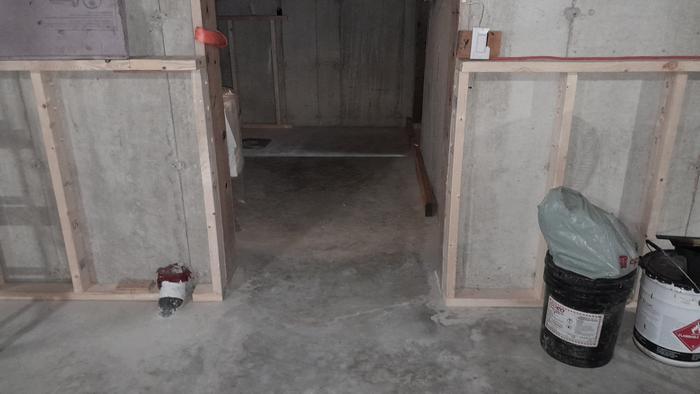 framing of pony walls against concrete walls in an underground house