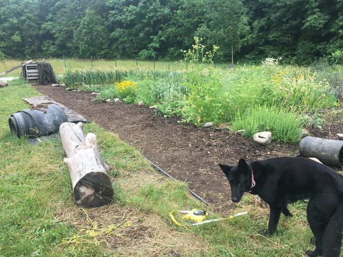 Perimeter weeded, tilled, weeded again awaiting edge ditching, fabric/mats, mulch, perimeter pegging