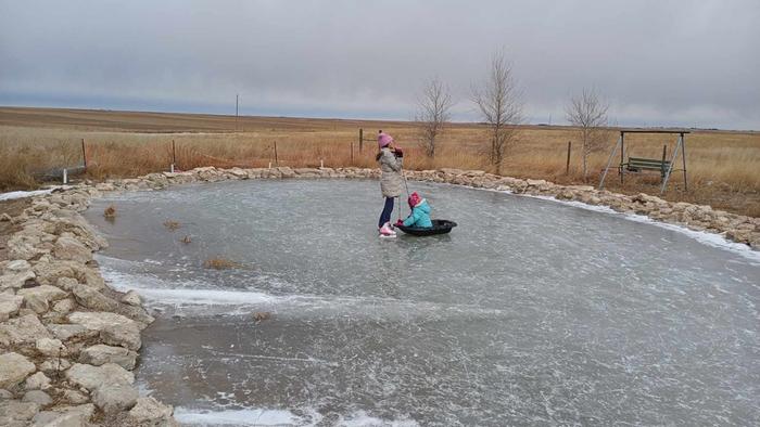 kids playing on frozen pond