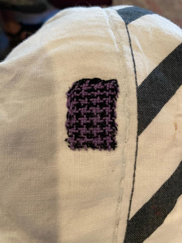 A houndstooth patch I wove with Sashiko thread and a Speedweve loom. It’s a bit shy of an inch wide!