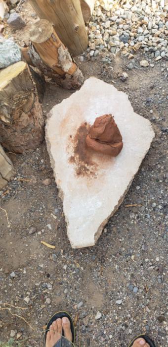 wet clay sitting on a rock