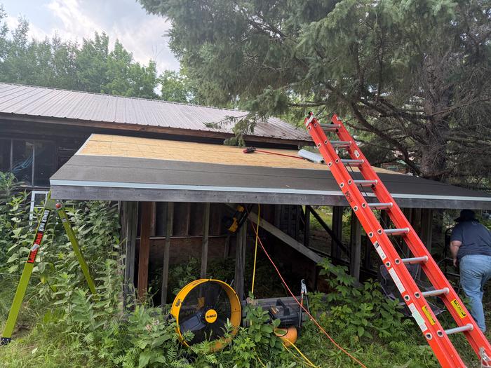This roll-roofing stuff is messy. That fan was out to dry out the roof after the rain.