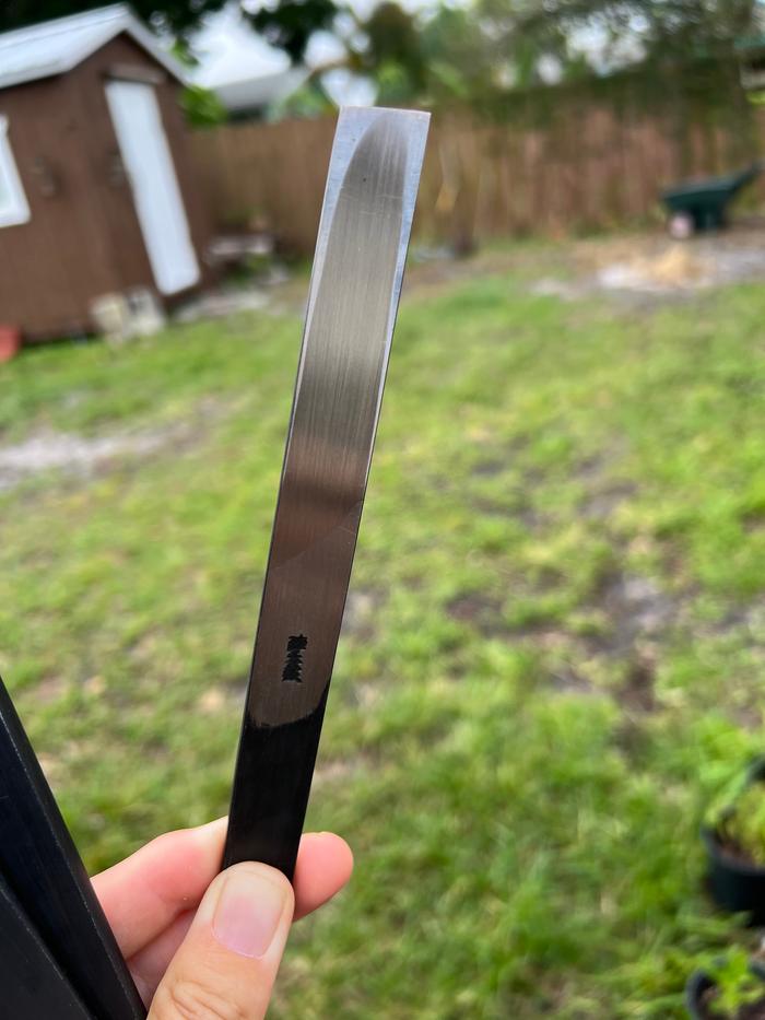 the hollowed out "U" shape on the back is called an ura. it makes sharpening the blade quick.