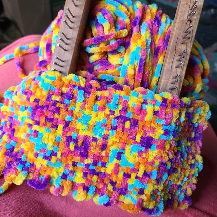Playing with a colorful chenille on a skipper loom