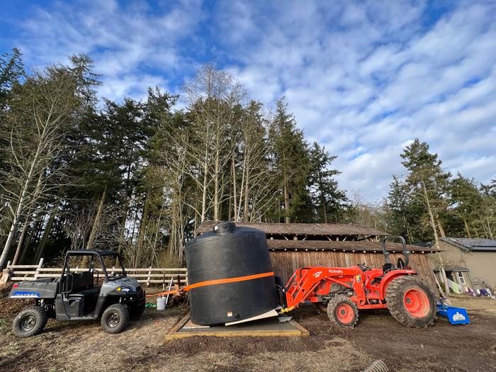 Anchoring the tank while backing the tractor out