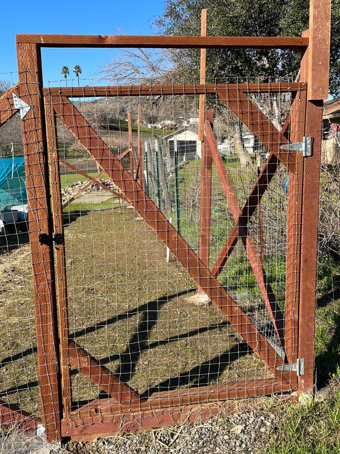 Example gate - outside posts are sunk in concrete and this one even has both a bottom and top support bar to keep shape.