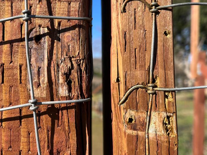 The holes and imprints on the wood are from where the original latch was installed. It's offset by nearly 2 inches in 2 years.