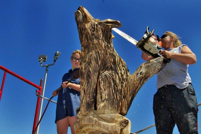 Chainsaw artist and his lovely assistant