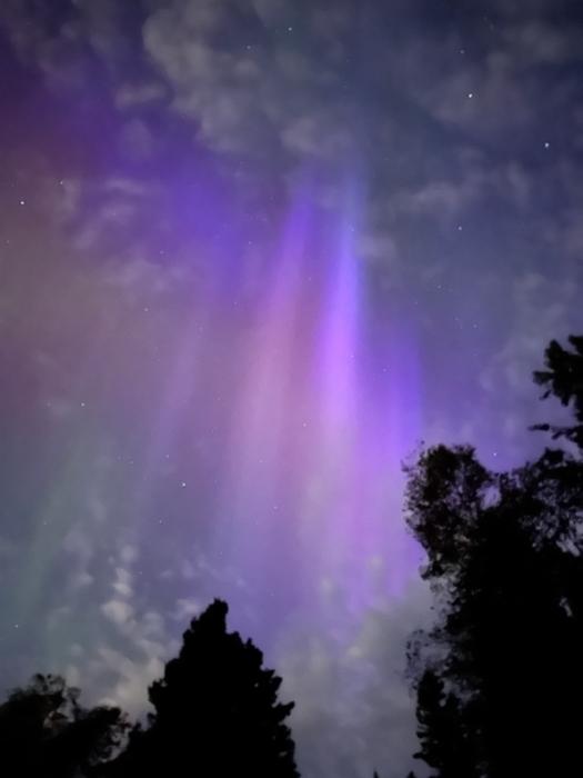 An aurora through clouds