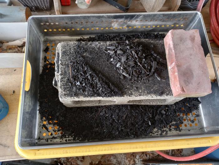 Biochar Grinding station, A strainer in a cement mixer a cinderblock and brick