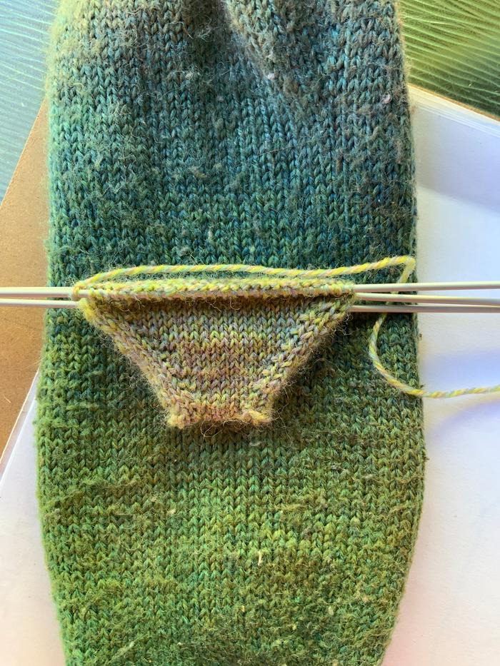 Large sock 8st/in, 2.25mm DPNs, no knitting stick. Sock in progress 9.5 st/in, 2mm DPNs, using knitting stick.