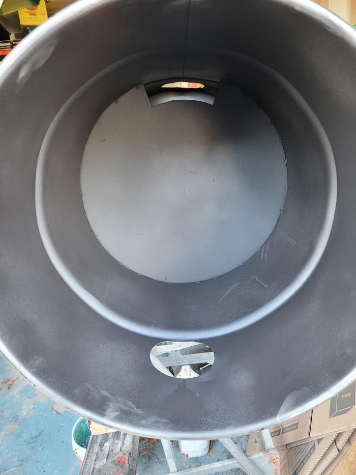 The outer barrel of a rocket oven with a baffle welded into it