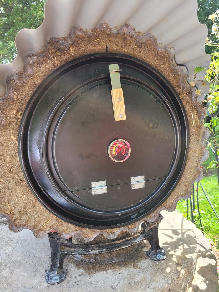 Front view of a completed rocket oven with insulation and door closed