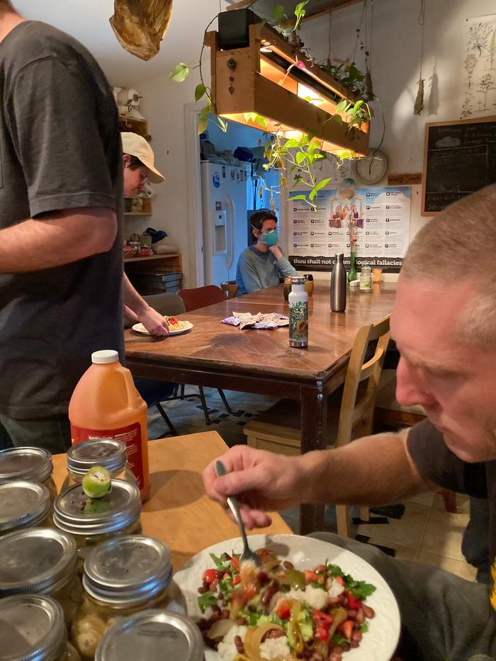 People eating mexican food under a planter