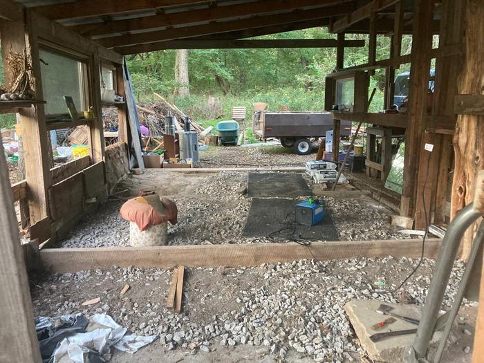 At the back looking out the front/south side. The board along the floor is serving as a retaining wall that will step down making the amount of fill material I need to level the floor less. 