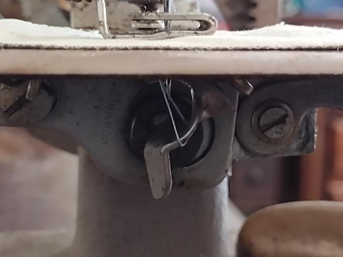 Loop slid off hook, hook grabbing thread from needle
