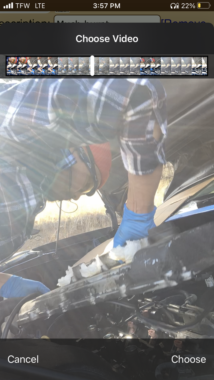 A screen shot of Dez Choi working on the valve cover of a car