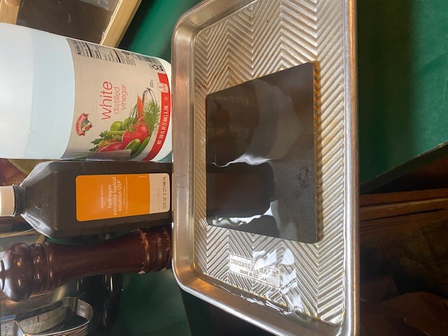 Utilizing vinegar, peroxide, and salt in a 3:1:1 to entirely saturate a piece of steel