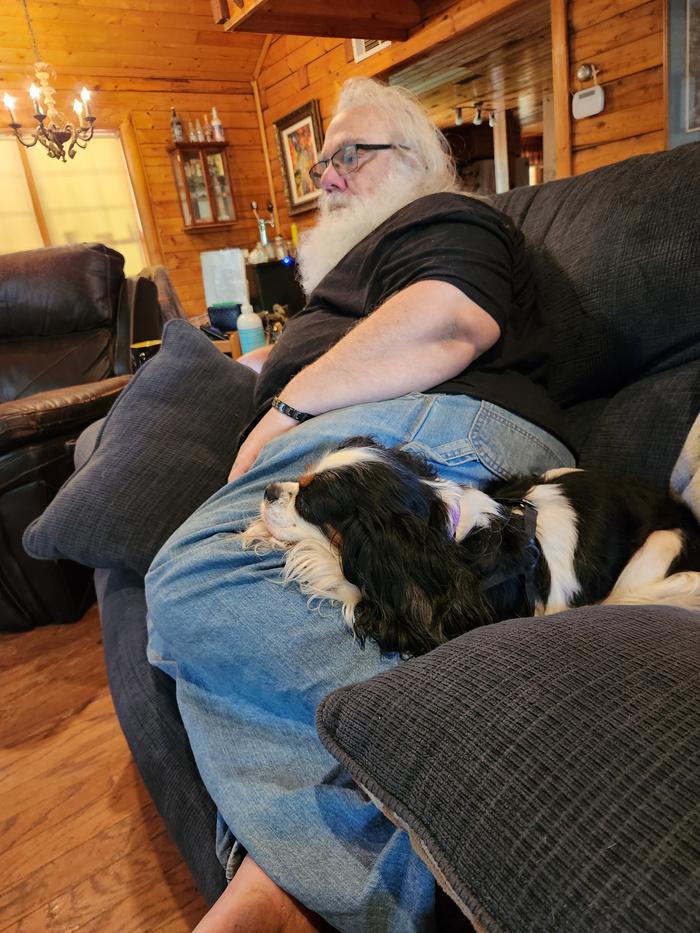 Charlie, aka Pwincess Buttahmiwk, aka Půgginz, aka, Sugar-Honey, who will be 7 in November, cozied up at John's knee - one of her favorite places. 