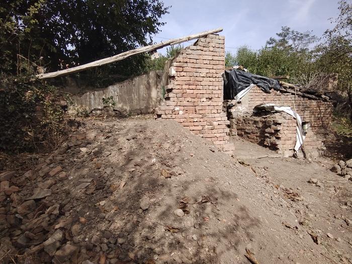 remainder of a brick wall that is being demolished