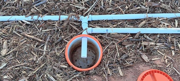 bucket with holes in the bottom to form the infiltration bed of a worm bin septic system