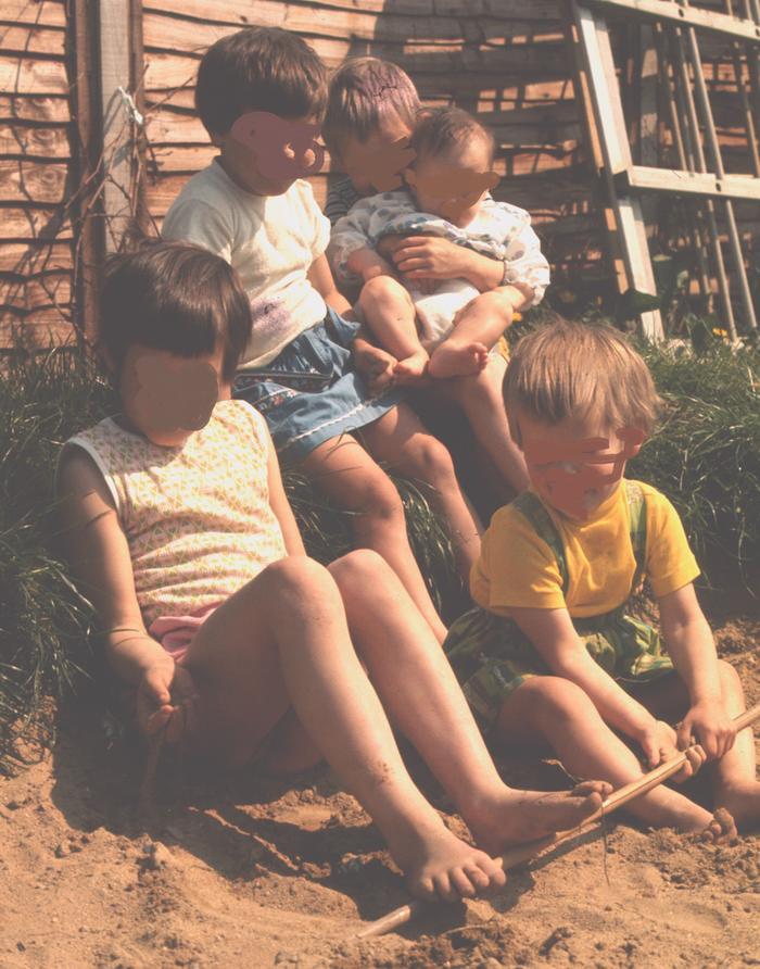 5 girls in a play sand pit