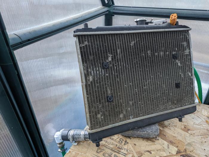 repurposed radiator for thermal mass in greenhouse