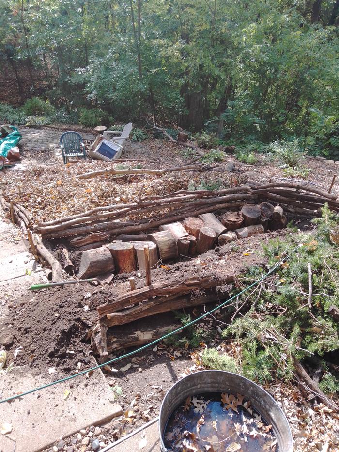 hugel terrace under construction with wattle retaining walls