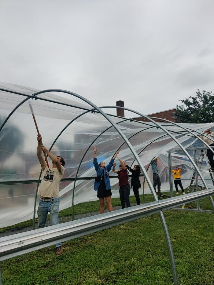 Hoop house plastic put on party