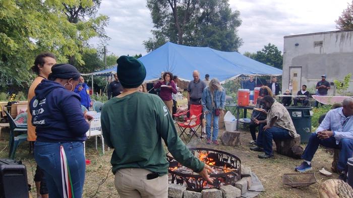 Gathering around a fire during a hugelculture workday