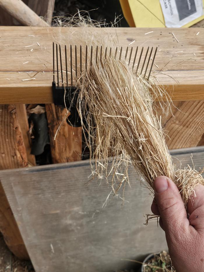 Next, I sent the little coarse handfuls of plant bits through a homeade hackle. 