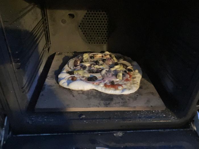 pizza in a black rocket oven