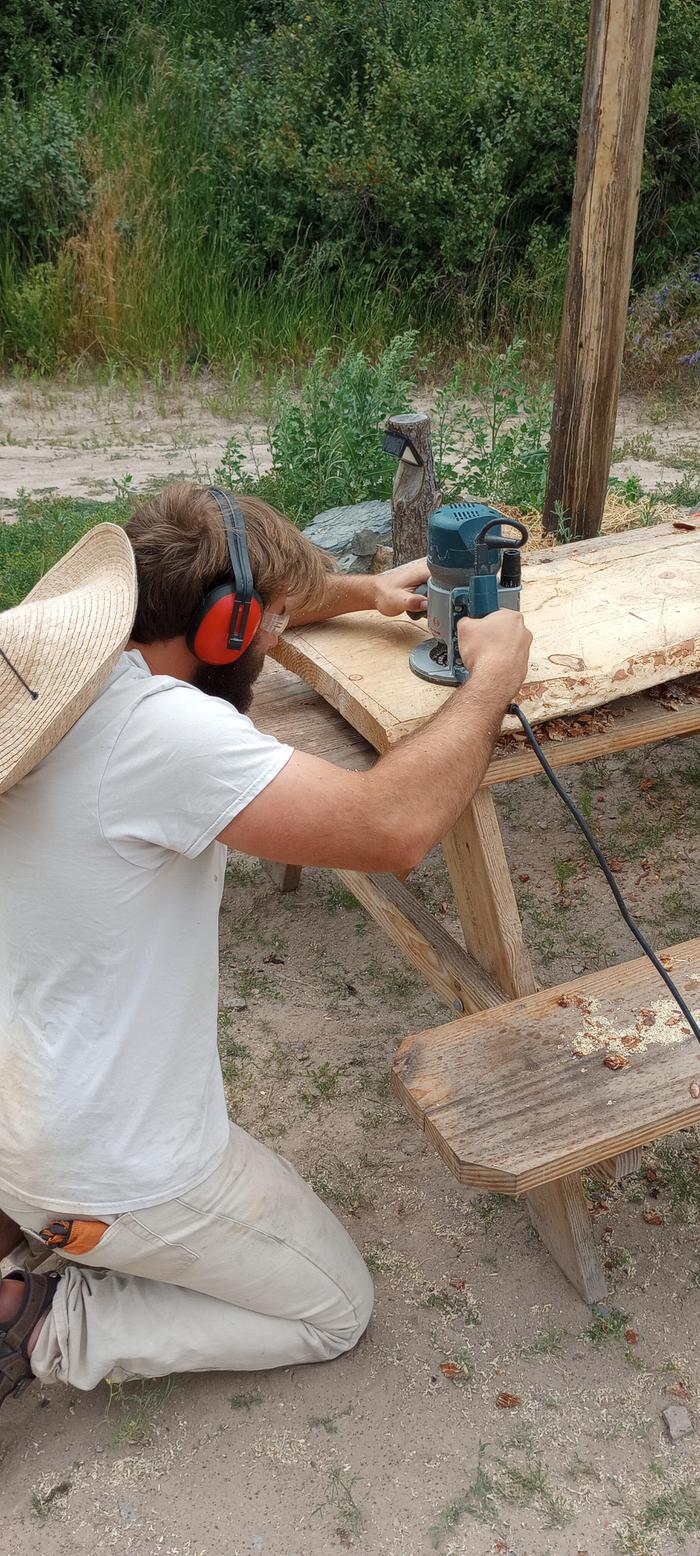 Ben using the router to make the leg slot