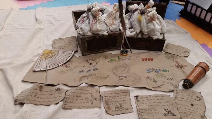 All the pouches the kids made, filled with treasure. The treasure map and clues