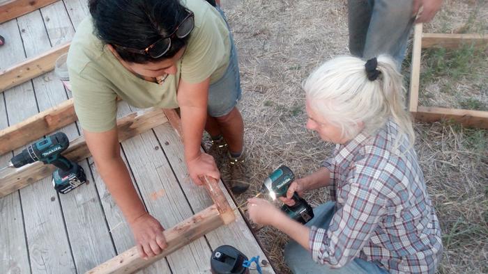 Suzanne and Pattilicious working on a wall