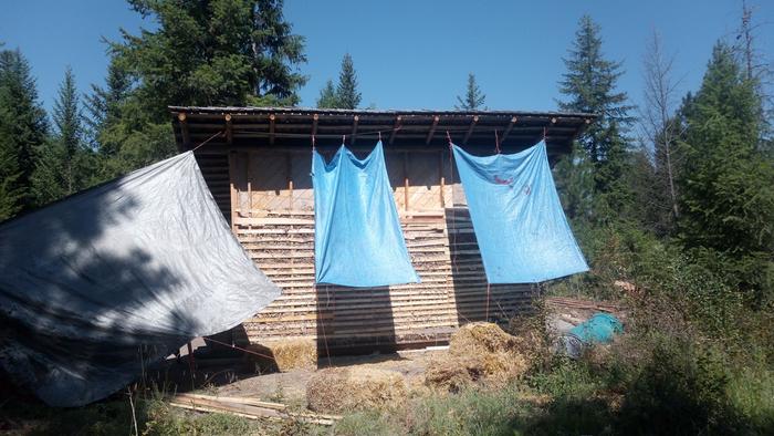 Our tarp system when we insulated the sauna last year - it was over 100°F, and we needed the shade in order to be able to work up there. This is one of the reasons a pole barn is so darn important... somewhere to work, shielded from the elements!