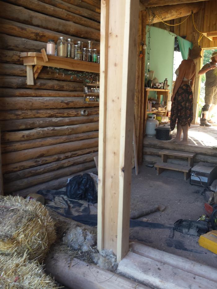 The door catch beam in place, along with a flattened log in the doorway to support the lintel.