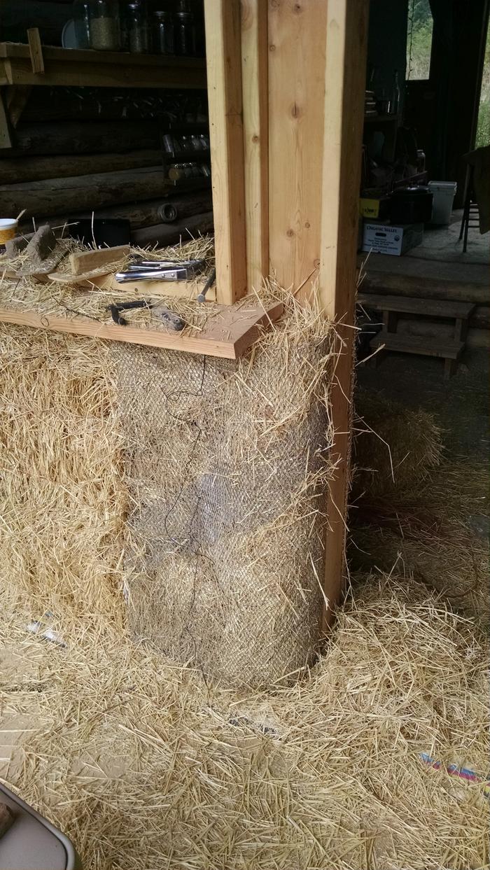Metal lath around the door beam, stuffed tight with straw.