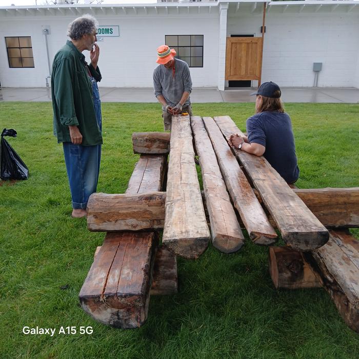 The (very heavy!!!) picnic table at the Montana State Fair. In this photo from L to R are Paul Wheaton, Boot Commander Stephen and fellow boot Scott