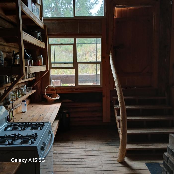 a kitchen and stairs to the porch in cooper cabin