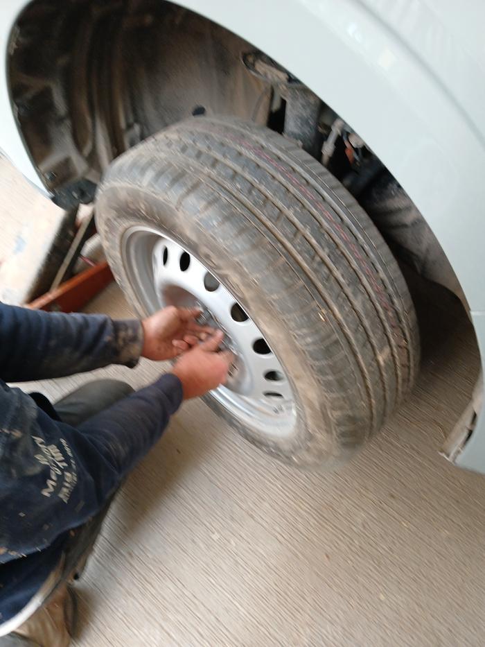 Ben getting lug nuts started on the newly installed spare