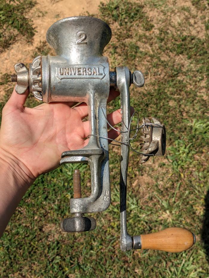 A 2 Universal meat grinder held in a hand outside