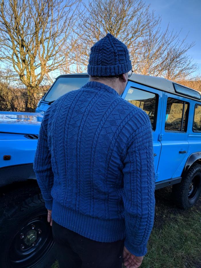 man wearing decorative blue woolen jumper