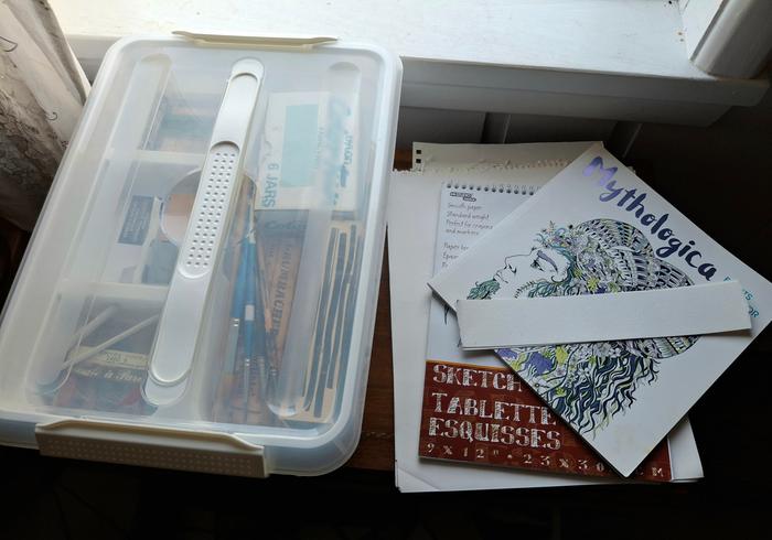 papers and tub of supplies